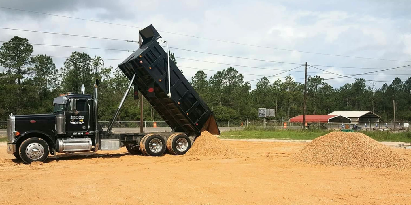 Black Nick's Peterbilt dump truck unloading rock